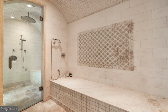 bathroom featuring vaulted ceiling and an enclosed shower