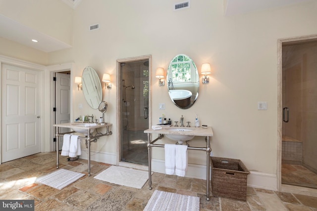 bathroom with an enclosed shower and a towering ceiling