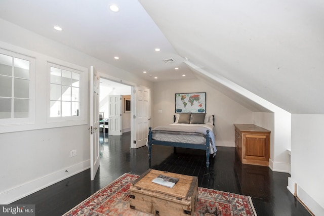 bedroom with dark wood-type flooring and vaulted ceiling