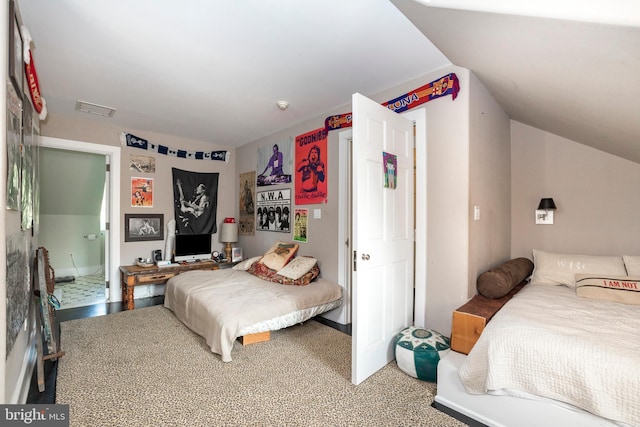 bedroom with vaulted ceiling and carpet