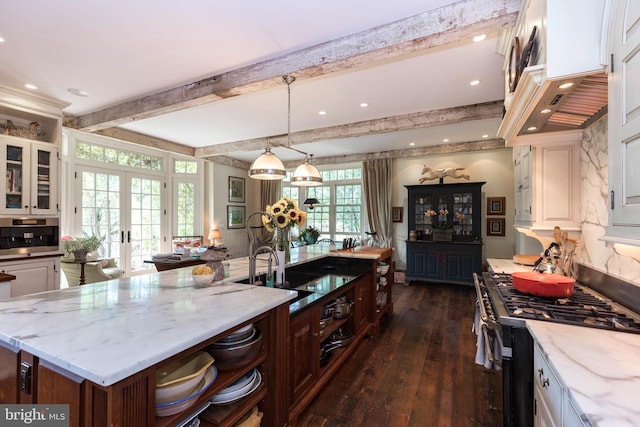 kitchen featuring hanging light fixtures, a center island, white cabinets, and appliances with stainless steel finishes