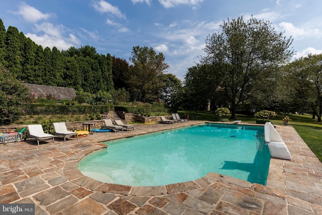 view of swimming pool featuring a patio