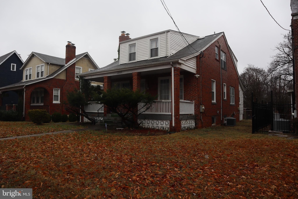 view of front of property with cooling unit and covered porch