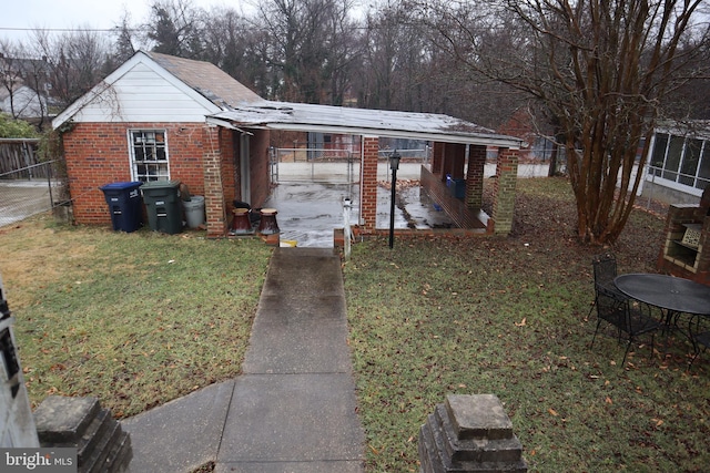 rear view of house with a yard