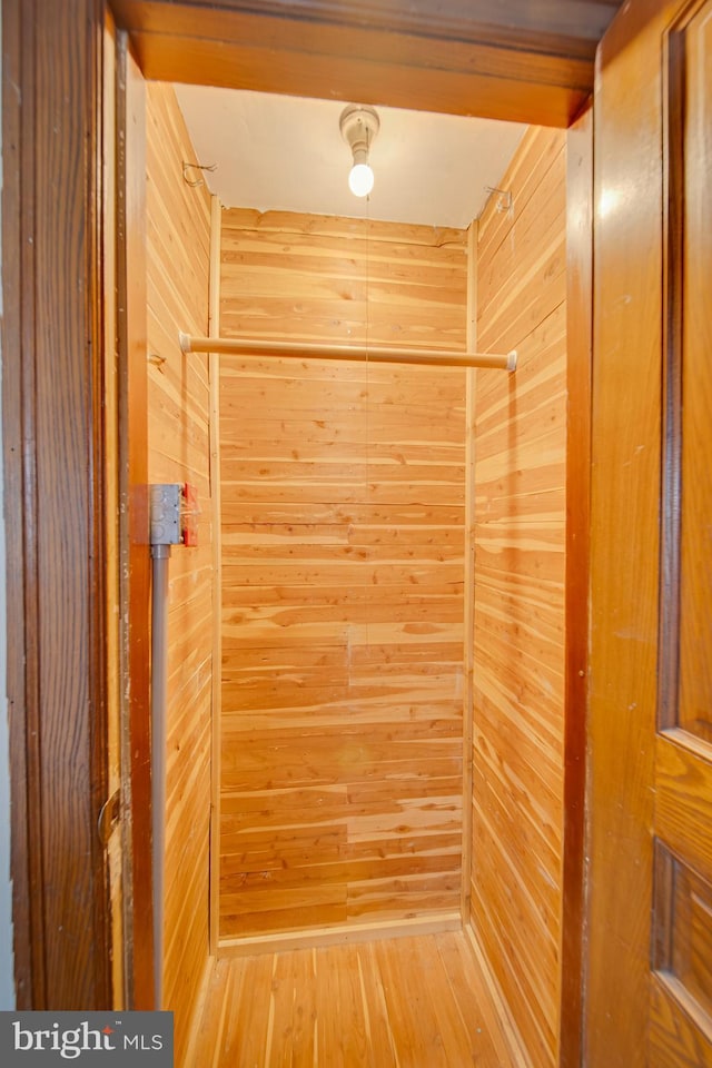 room details featuring hardwood / wood-style flooring and wood walls