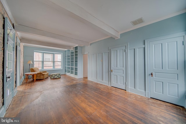 interior space with crown molding, hardwood / wood-style flooring, and beamed ceiling