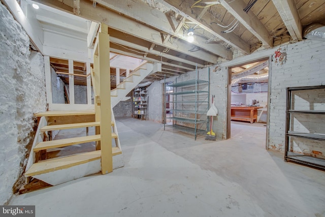 unfinished basement featuring stairs