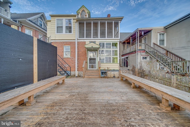 wooden terrace featuring a sunroom