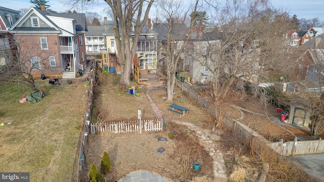 exterior space featuring a residential view and fence