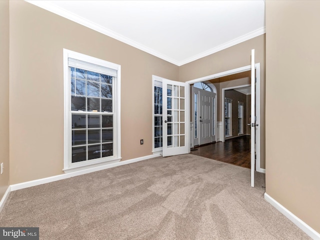 carpeted empty room featuring crown molding