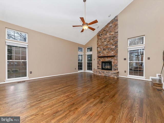 unfurnished living room with hardwood / wood-style flooring, a fireplace, high vaulted ceiling, and ceiling fan