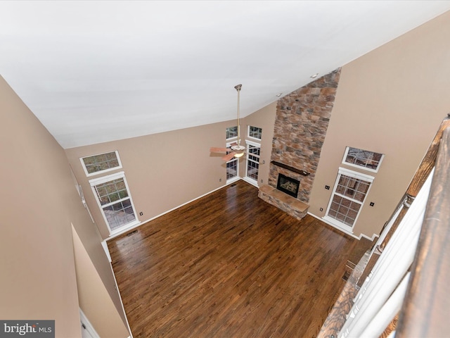 living room with wood-type flooring, high vaulted ceiling, and a fireplace