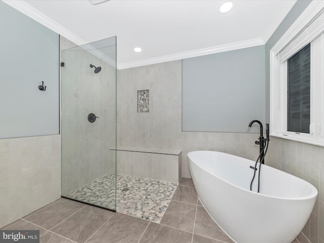 bathroom with crown molding, tile patterned floors, shower with separate bathtub, and tile walls