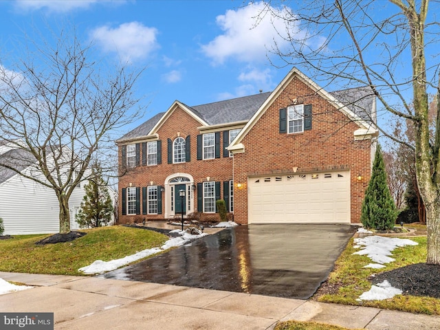 view of front of house featuring a garage and a front yard