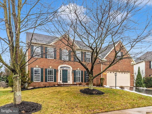 colonial inspired home featuring a garage and a front yard