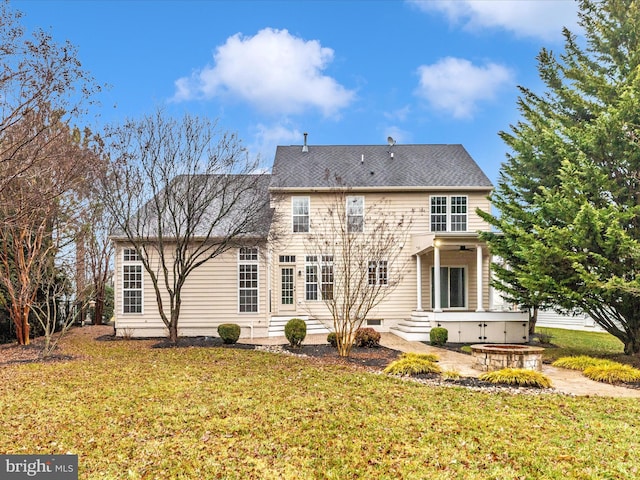 rear view of property featuring a yard and a patio