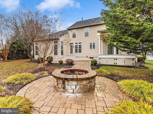 rear view of house featuring a patio area and a fire pit