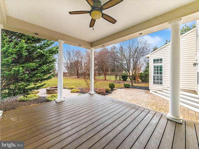 wooden deck featuring ceiling fan and an outdoor fire pit