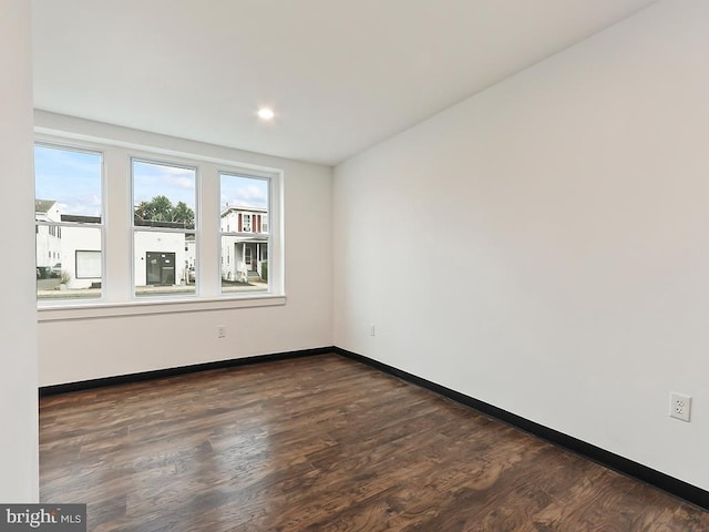 empty room with dark hardwood / wood-style floors