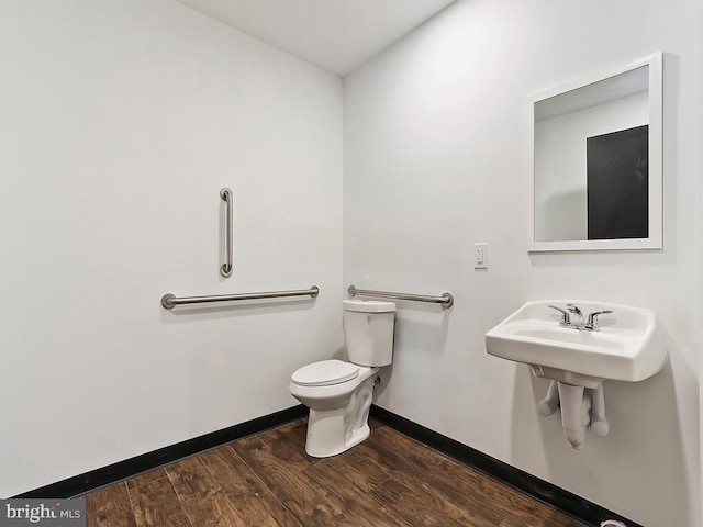 bathroom with hardwood / wood-style floors and toilet