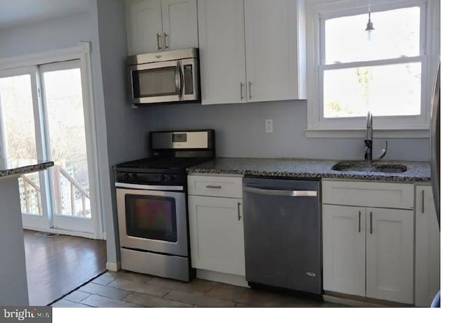 kitchen featuring sink, white cabinets, and appliances with stainless steel finishes