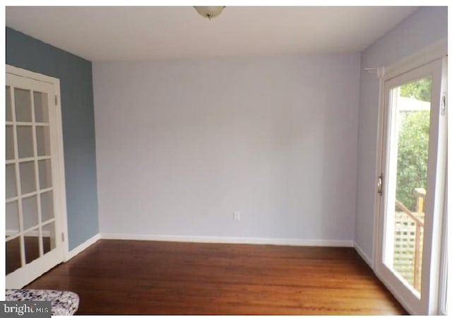 empty room with hardwood / wood-style floors