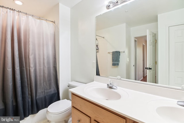 bathroom with vanity, toilet, and a shower with shower curtain