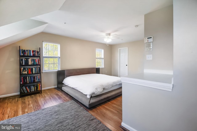 bedroom with wood-type flooring, vaulted ceiling, and ceiling fan