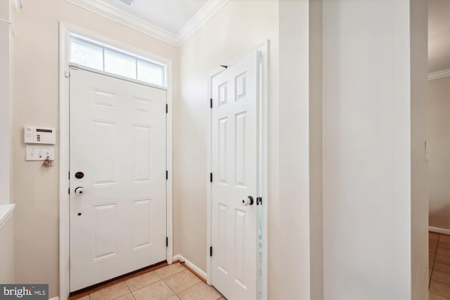 tiled foyer entrance featuring ornamental molding