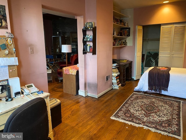 bedroom featuring wood-type flooring and a closet