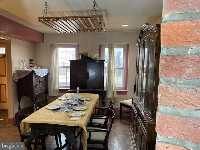 dining area featuring dark parquet flooring