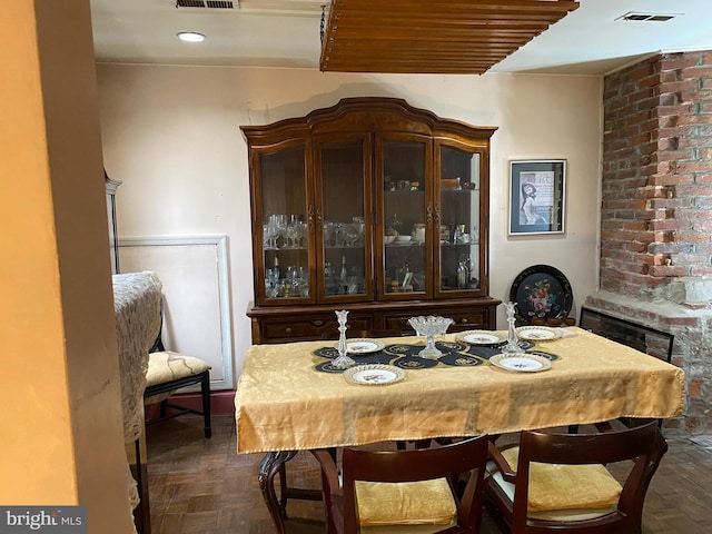 dining space featuring dark parquet floors