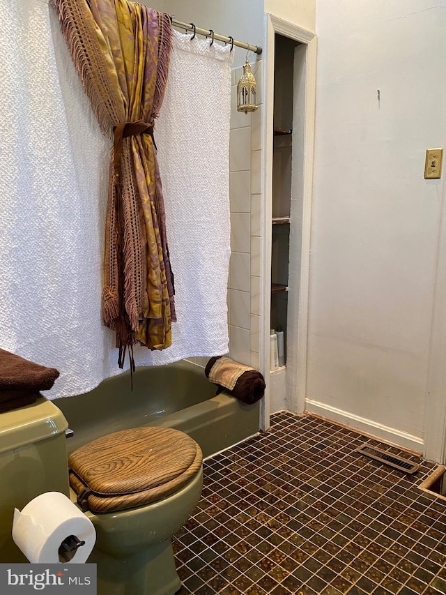 bathroom featuring shower with separate bathtub and toilet