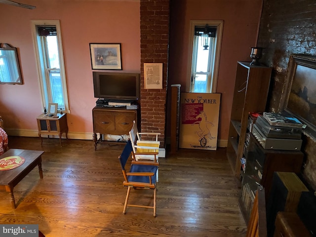 sitting room featuring a healthy amount of sunlight and dark hardwood / wood-style flooring