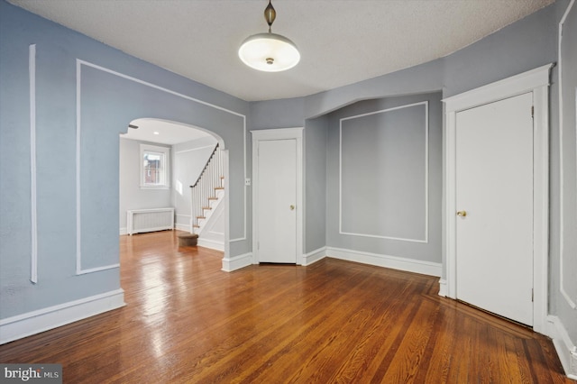 interior space featuring dark hardwood / wood-style flooring and radiator