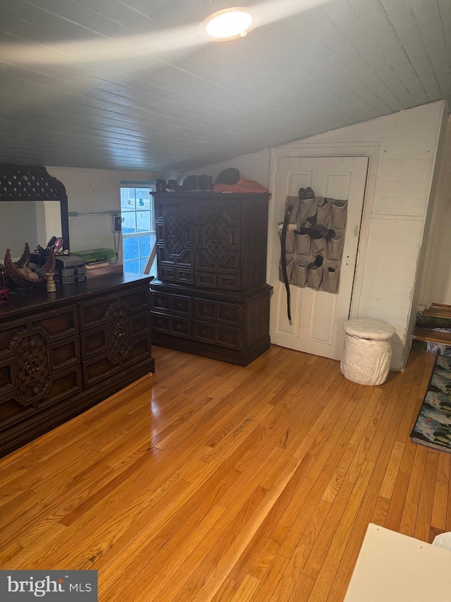 bedroom featuring lofted ceiling, light hardwood / wood-style floors, and wooden ceiling