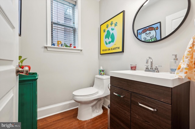 bathroom with hardwood / wood-style flooring, vanity, and toilet