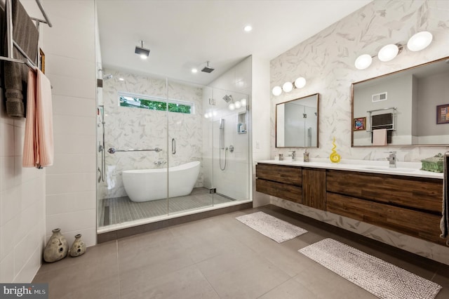 bathroom featuring vanity, tile patterned flooring, and plus walk in shower