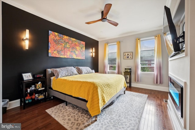 bedroom featuring crown molding, dark hardwood / wood-style floors, and ceiling fan