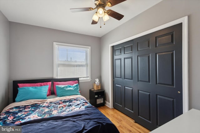 bedroom with ceiling fan, a closet, and light hardwood / wood-style flooring