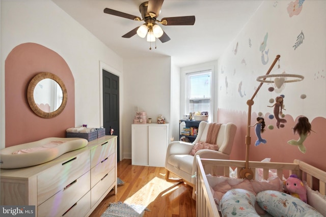 bedroom featuring ceiling fan and light hardwood / wood-style flooring