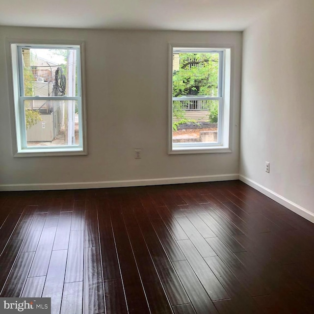 unfurnished room featuring dark wood-type flooring