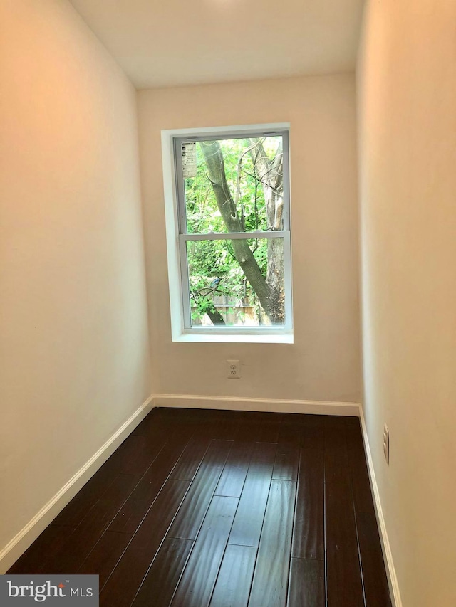 empty room with dark wood-type flooring