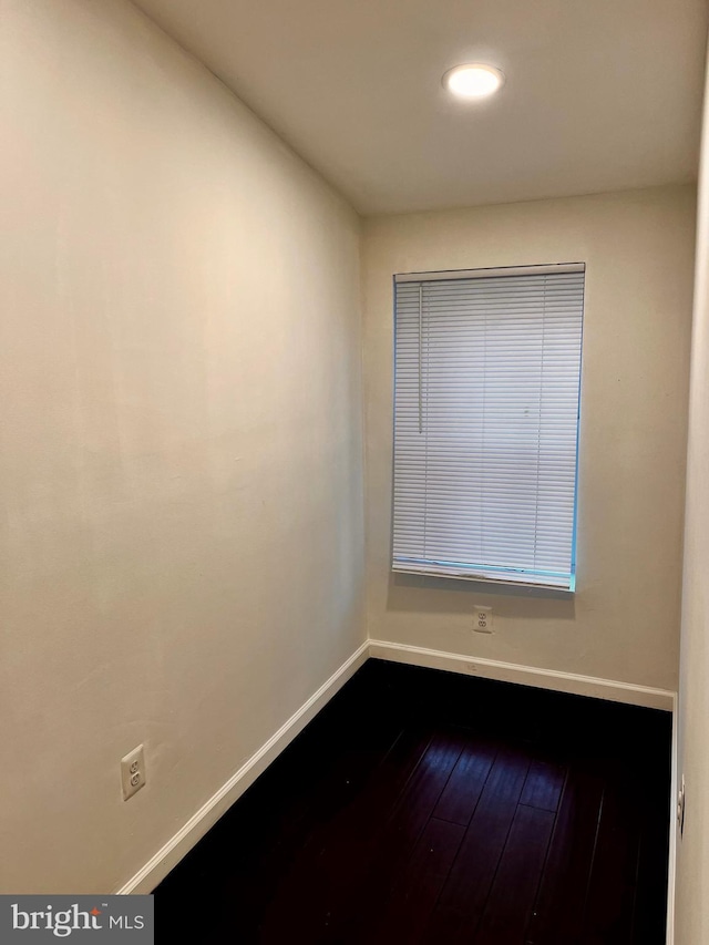 empty room with hardwood / wood-style floors