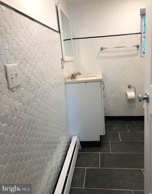 bathroom featuring vanity, tile patterned floors, and tile walls