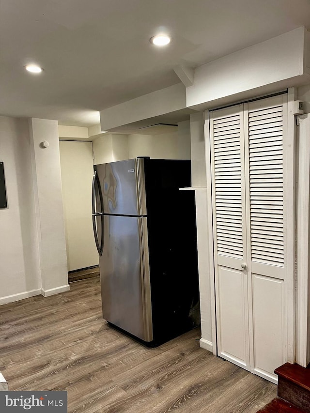 kitchen with hardwood / wood-style flooring and stainless steel fridge