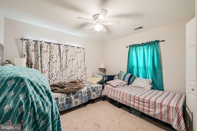 bedroom featuring ceiling fan and carpet