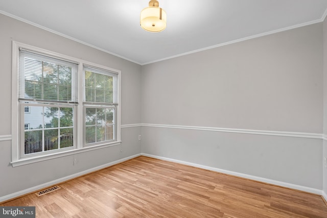 unfurnished room with ornamental molding and light hardwood / wood-style floors