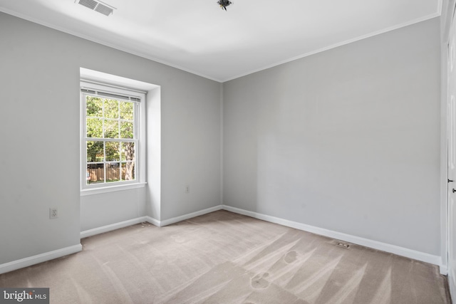 unfurnished room featuring crown molding and light colored carpet