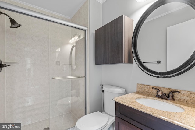 bathroom with crown molding, toilet, vanity, and walk in shower